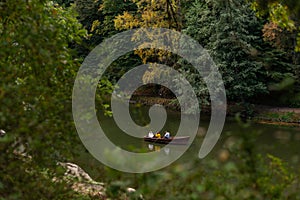 Boat with people in a lake in the forest Sofievka park Uman
