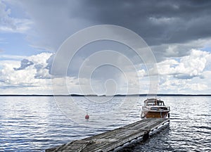 Boat at the pier next to lake photo