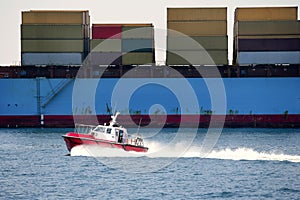 Boat port pilots compared to cargo container photo