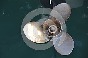 Boat propeller on green water background