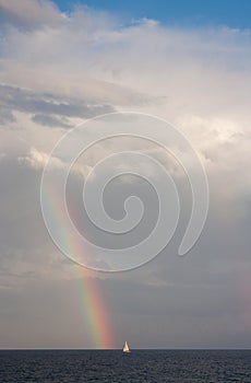 A boat, and a rainbow above the sea in Sydney