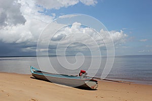 A boat rests on the sands of one of the river beaches photo