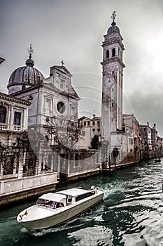 Boat in Rio del Greci near the campanile of church San Giorgio dei Greci, Venice, Italy
