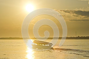 Boat on river amazon at sunset
