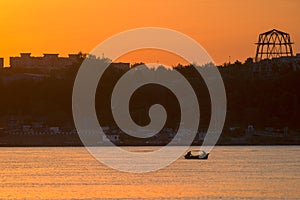 Boat on river at dawn in summer tine