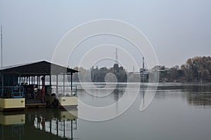 Boat on a river with a factory on the other side