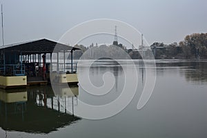 Boat on a river with a factory on the other side