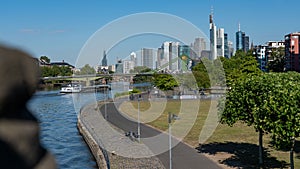 Boat in the river of Main near the skyline of Frankfurt, Hesse, Germany