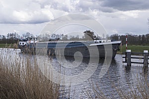 Boat in river Oude IJssel approaches lift bridge