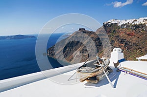 Boat on the roof. White architecture of Oia village on Santorini island, Greece