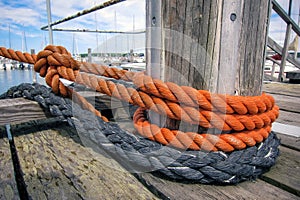 Boat ropes and wooden bollard