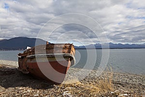 Boat run aground in a beach at fagnano lake photo