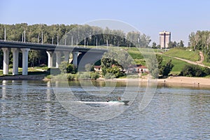 The boat rushes under the bridge