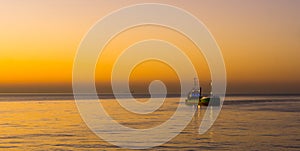 Boat sailing at the belgian coast of Blankenberge during sunset, the sea of Belgium