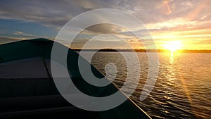 Boat sailing at high speed during sunset in Baja California