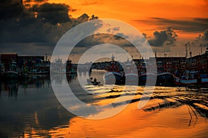 boat sailing through Rayong port at sunrise