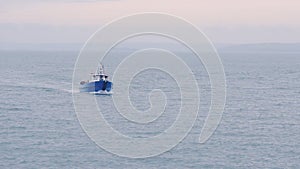 A Boat Sailing Swiftly Across The Big Blue Ocean In Skomer Island, Wales, UK - W