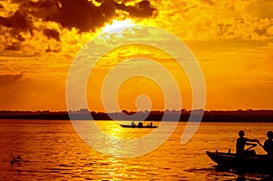 boat sailors at sunrise sunset photo