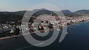 The boat sails along the city beach. Aerial view