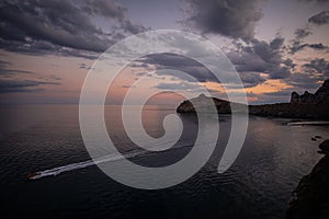 The boat sails on the Black Sea in the evening