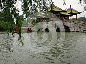 Boat Sails Under Chinese Bridge