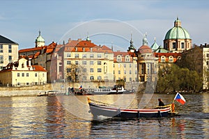 Boat sails on Vltava river in central Prague