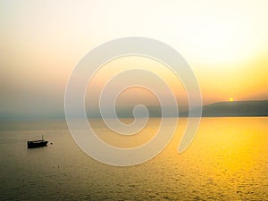 Fishing Boat on Sea of Galilee at Sunrise photo