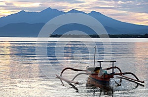 The boat in the sea in the morning near Rinjani volcano