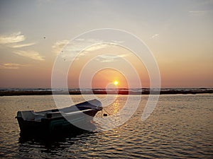 Boat on sea at sunset