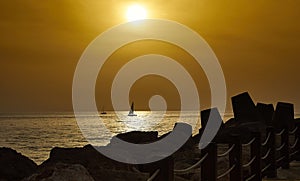 A boat at sea at sunset in golden light