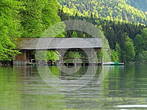 Boat shed at mountain lake and forest, spring season nature