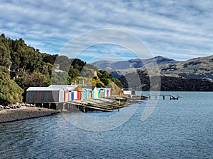 Boat sheds with colourful door in Duvachelle bay, Canterbury region of the South Island of New Zealand