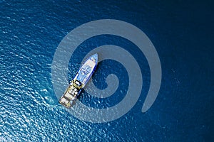 Boat and ship in beautiful turquoise ocean, top view.