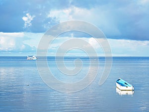 Boat and ship in the blue sea