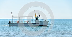 Boat or ship navigating on blue Black Sea water, entertaiment yacht
