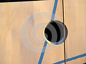 Boat ship window porthole on white wooden wall