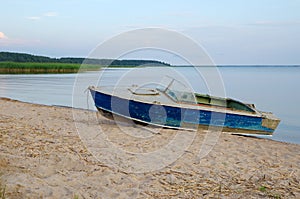 Boat on the shore of Lake Seliger on a summer evening. Tver Region, Russia