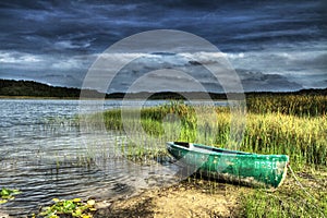 Boat on the shore of the lake before the storm