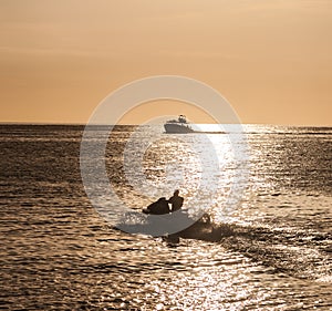 Boat silhouetted in the setting sun