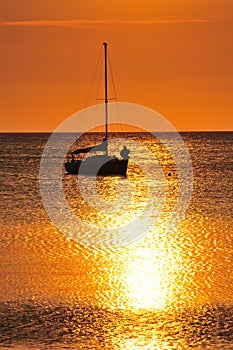 Boat silhouetted at sunset photo