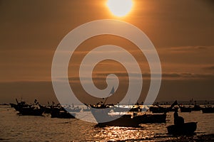Boat Silhouettes in Ocean at Sunset and Sun Disk in Sky