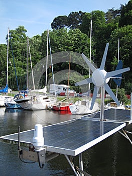 Boat with a solar panel and a wind turbine in the port of LÃ©gu