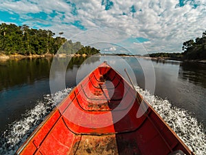 Boat speeding down an Amazon river in Venezuela