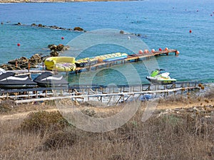 Boat station with water attractions near beautiful beach in Cyprus