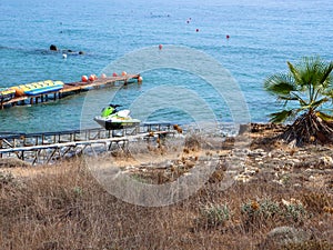 Boat station with water attractions near beautiful beach in Cyprus