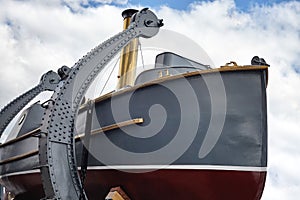 Boat with steam engine aboard the old military cruiser