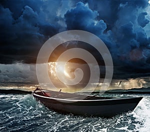 Boat in stormy sea photo