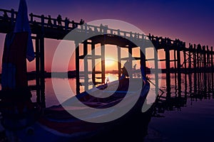 Boat at Sunset in front of the U Bein Bridge Taungthaman Lake Amarapura Myanmar