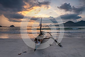 Boat and Sunset at Selong Belanak Beach photo