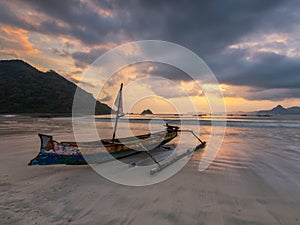 Boat and Sunset at Selong Belanak Beach photo